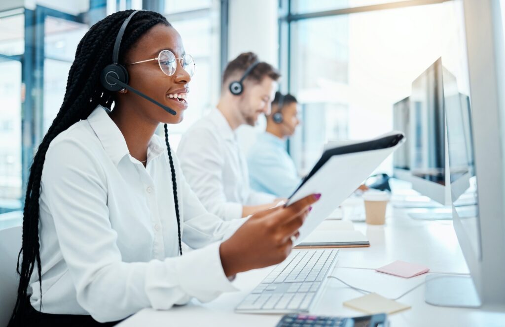 Contact us, customer support and happy call center consultant working in office, smiling while help